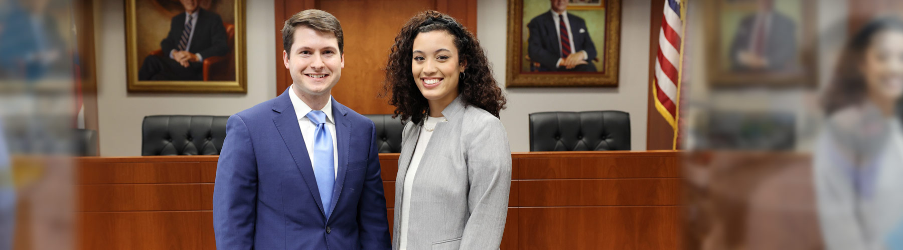 Two law students standing in a court room
