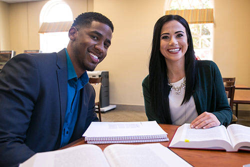 Two law students studying in the library